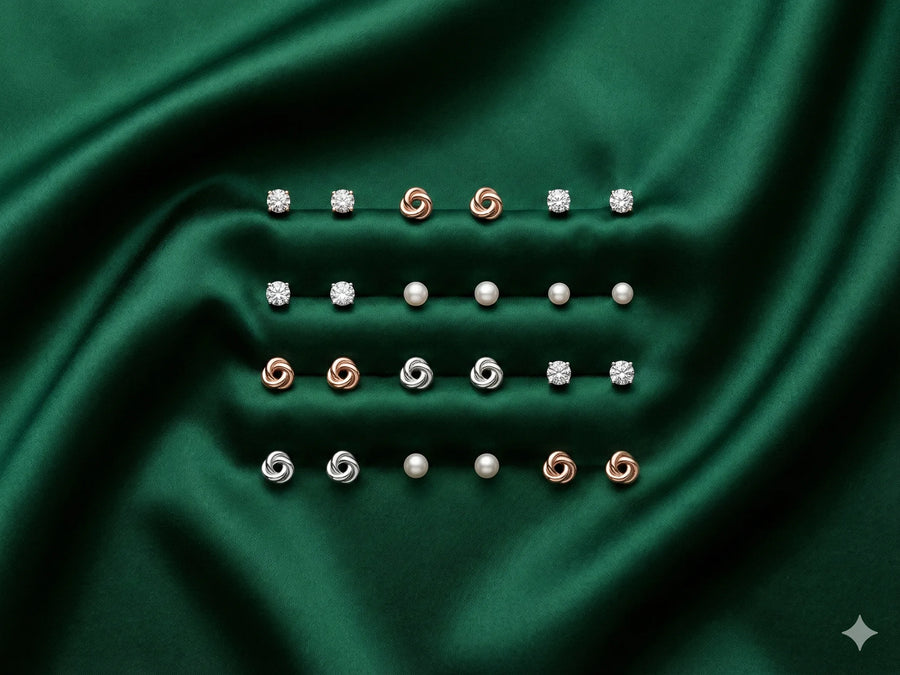 Collection of earrings on a green fabric background